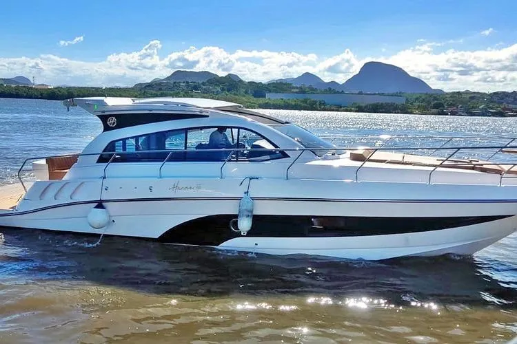 Slide: The Image of 2026 Hanover 415 Inboard yacht cruising on a sunny day with scenic mountain backdrop. - 2