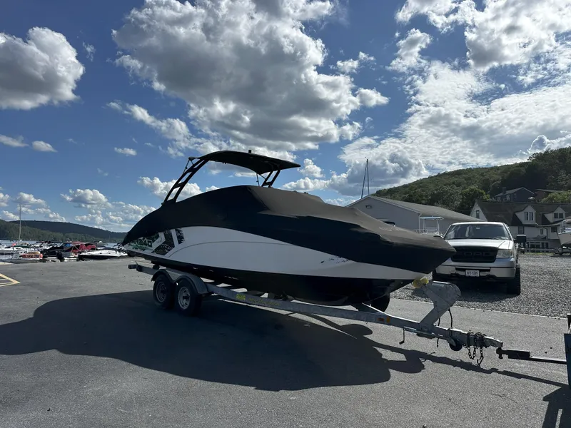 Slide: The Image of 2016 Yamaha AR240 boat on trailer under a cloudy sky. - 3