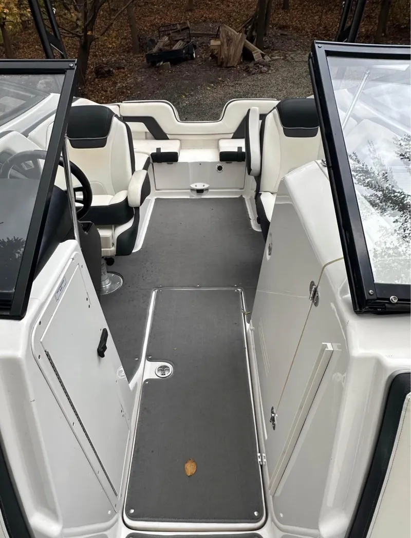 Slide: The Image of 2016 Yamaha AR240 boat interior with seating and helm, featuring sleek design and spacious layout. - 7