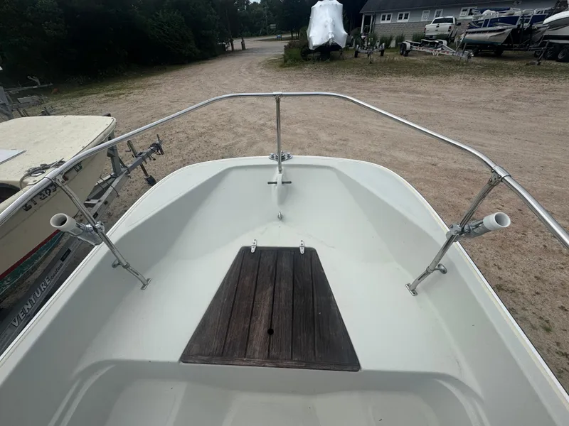 Slide: The Image of 1984 Boston Whaler 170 Montauk boat deck with wooden platform and rod holders. - 10