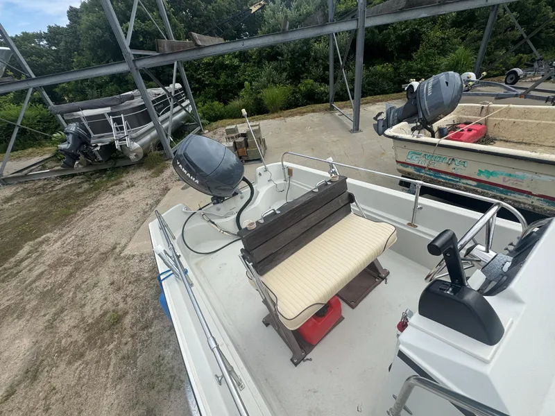 Slide: The Image of 1984 Boston Whaler 170 Montauk boat with Yamaha outboard motor in storage yard. - 12
