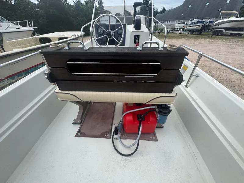 Slide: The Image of 1984 Boston Whaler 170 Montauk boat interior with steering wheel and fuel tank. - 15