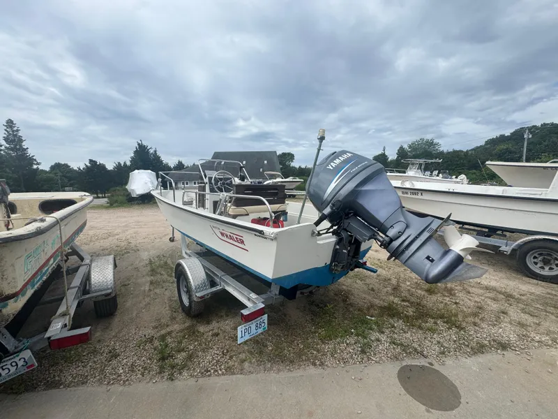 Slide: The Image of 1984 Boston Whaler 170 Montauk boat with Yamaha outboard motor on a trailer. - 16