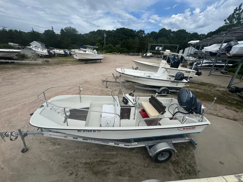 Slide: The Image of 1984 Boston Whaler 170 Montauk boat on trailer in outdoor storage area. - 18
