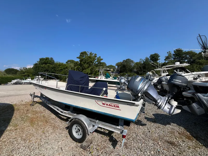 Slide: The Image of 1984 Boston Whaler 170 Montauk boat on trailer, equipped with Yamaha outboard motor. - 21