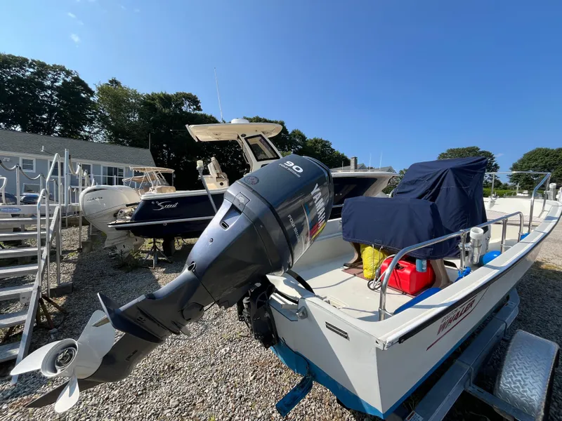 Slide: The Image of 1984 Boston Whaler 170 Montauk with Yamaha outboard motor, parked outdoors. - 23