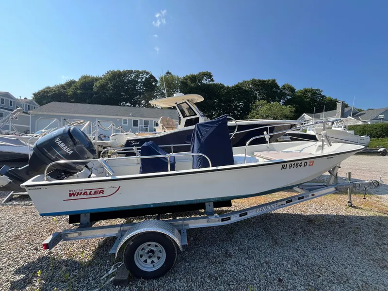 Slide: The Image of 1984 Boston Whaler 170 Montauk boat on trailer, with Yamaha outboard motor. - 25