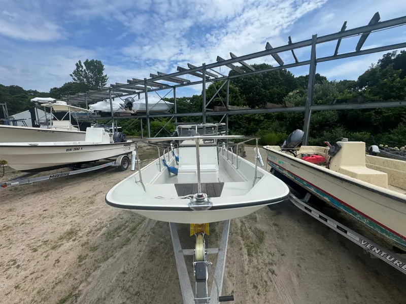 Slide: The Image of 1984 Boston Whaler 170 Montauk boat on trailer, outdoor storage, clear sky. - 3