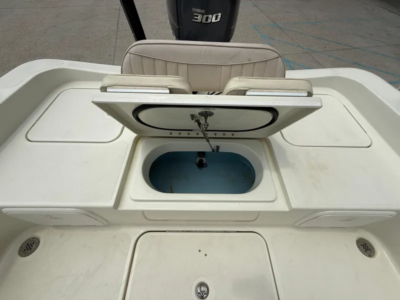 Slide: The Image of 2012 Hydra-Sports 23 Bay Bolt boat with open storage compartment and Yamaha 300 engine. - 18