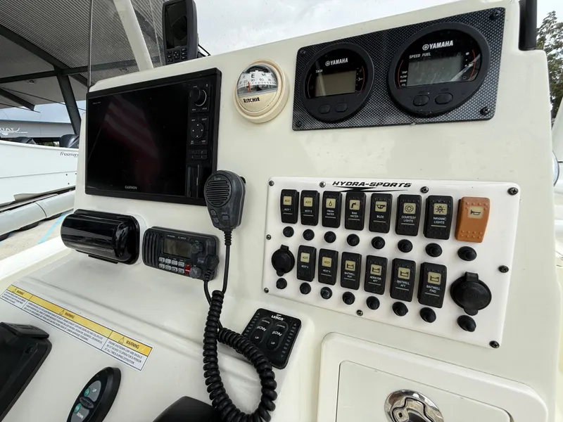 Slide: The Image of 2012 Hydra-Sports 23 Bay Bolt dashboard with Garmin display and Yamaha gauges. - 21