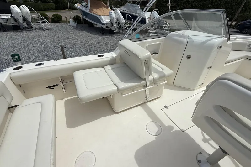 Slide: The Image of 2017 Cobia 220 Dual Console boat interior with seating and storage compartments. - 11