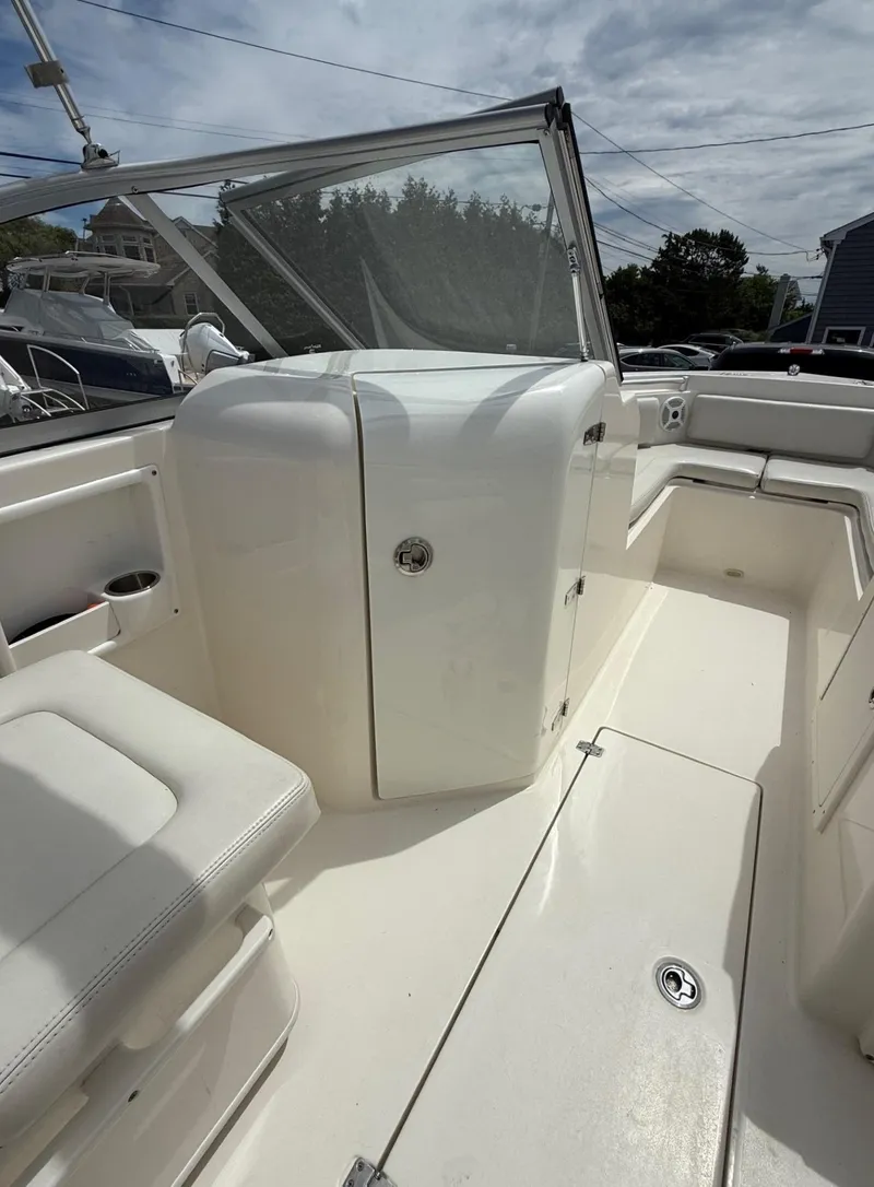 Slide: The Image of 2017 Cobia 220 Dual Console boat interior with seating and storage compartments. - 12