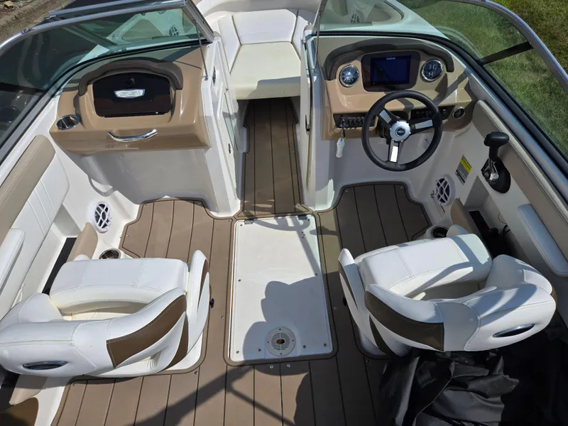 Slide: The Image of 2022 Chaparral 21 SSi boat interior with dual seats and modern dashboard. - 11