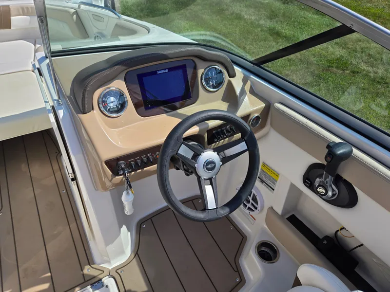 Slide: The Image of 2022 Chaparral 21 SSi boat dashboard with steering wheel and control panel. - 15