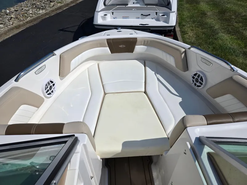 Slide: The Image of 2022 Chaparral 21 SSi boat interior with white and beige seating. - 18