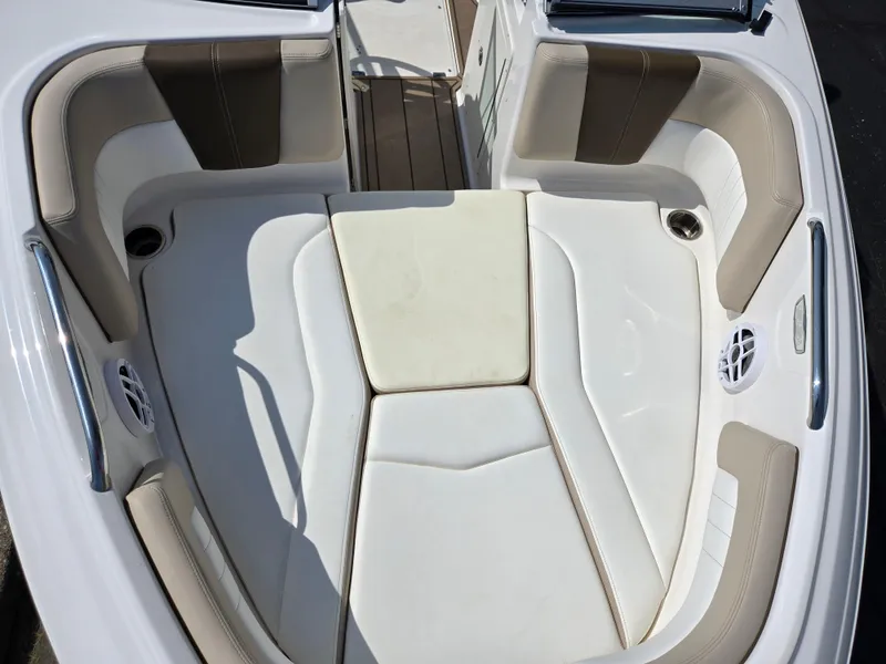 Slide: The Image of 2022 Chaparral 21 SSi boat interior with white and beige seating. - 20