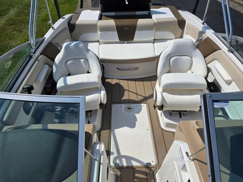 Slide: The Image of 2022 Chaparral 21 SSi boat interior with white seating and tan flooring. - 22