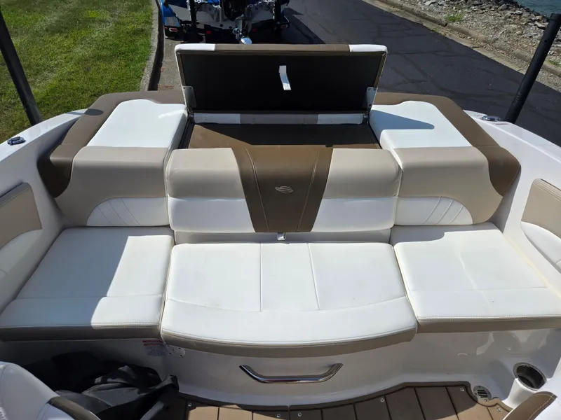 Slide: The Image of 2022 Chaparral 21 SSi boat interior with beige and white seating. - 23