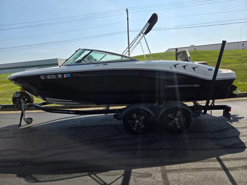 Slide: The Image of 2022 Chaparral 21 SSi boat on trailer, parked outdoors on a sunny day. - 4