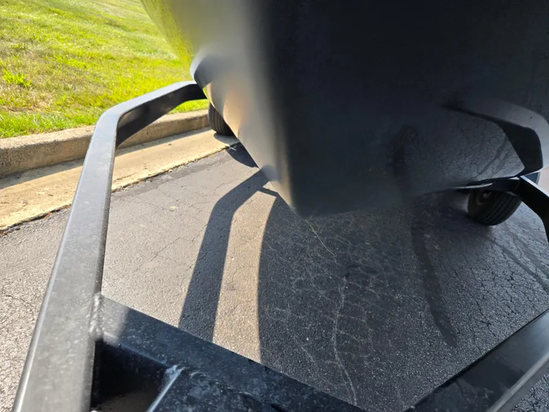 Slide: The Image of 2022 Chaparral 21 SSi boat on trailer, close-up view of hull and wheels. - 7