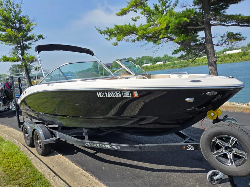 Slide: The Image of 2022 Chaparral 21 SSi boat on trailer by a lakeside road. - 8