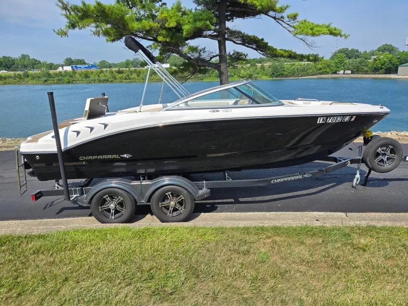 Slide: The Image of 2022 Chaparral 21 SSi boat on trailer by a lake, side view. - 9