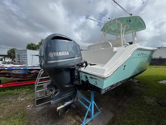 Slide: The Image of 2015 Cobia 296 Center Console boat with Yamaha outboard motor on display. - 1
