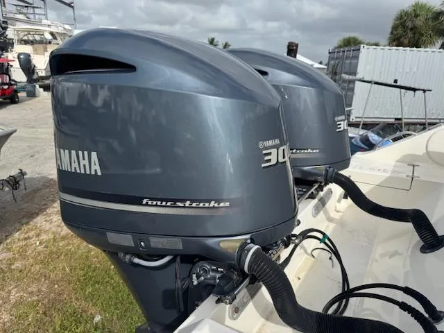 Slide: The Image of Twin Yamaha 300 four-stroke engines on a 2015 Cobia 296 Center Console boat. - 11