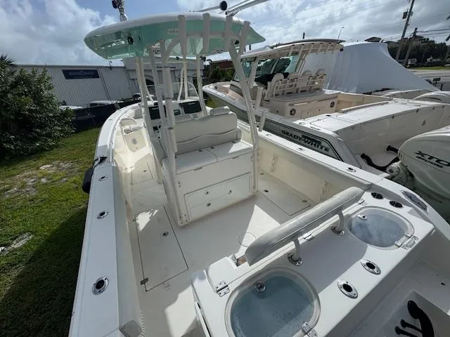 Slide: The Image of 2015 Cobia 296 Center Console boat with spacious deck and seating. - 12