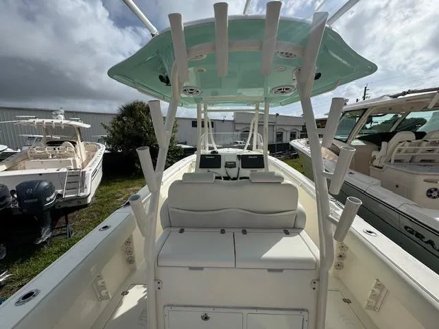 Slide: The Image of 2015 Cobia 296 Center Console boat with dual seats and rod holders. - 13