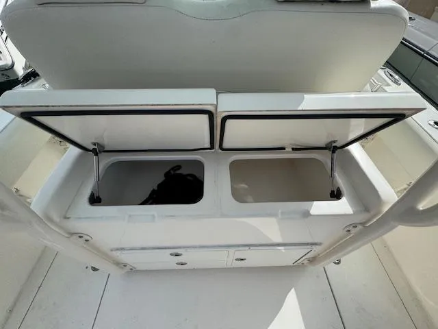 Slide: The Image of 2015 Cobia 296 Center Console boat storage compartments open, showcasing interior space. - 14