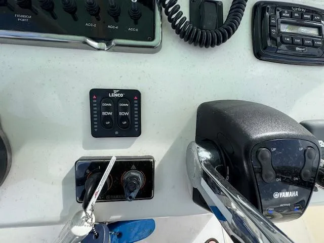 Slide: The Image of Control panel of a 2015 Cobia 296 Center Console boat with Yamaha throttle. - 22