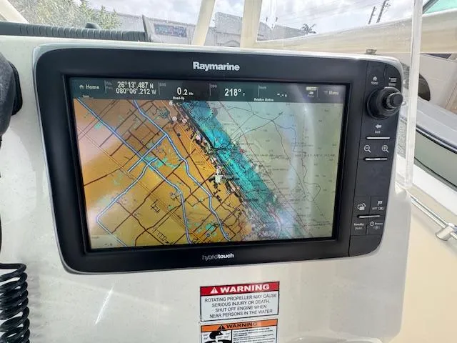 Slide: The Image of Raymarine navigation system on 2015 Cobia 296 Center Console boat displaying nautical chart. - 23
