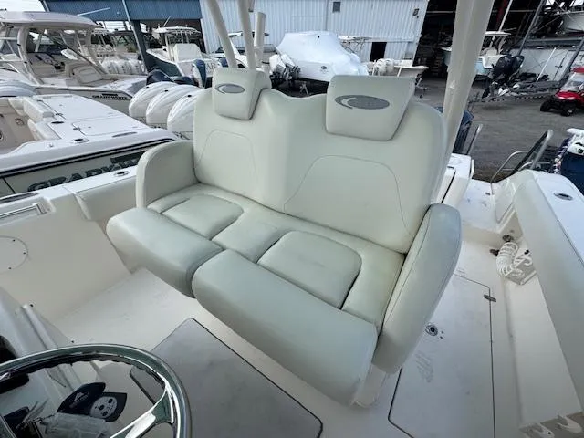 Slide: The Image of 2015 Cobia 296 Center Console boat with white cushioned seating. - 26