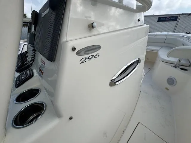 Slide: The Image of 2015 Cobia 296 Center Console boat interior with control panel and seating area. - 27