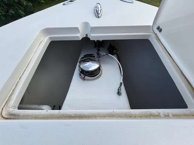 Slide: The Image of 2015 Cobia 296 Center Console anchor compartment with open hatch. - 29