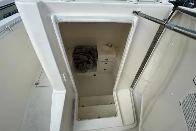 Slide: The Image of 2015 Cobia 296 Center Console storage compartment with open hatch and interior view. - 31
