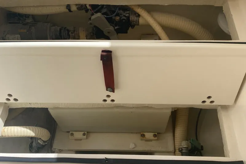 Slide: The Image of 2015 Cobia 296 Center Console boat interior with visible hoses and compartments. - 34
