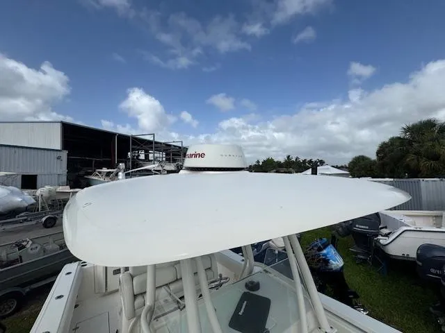 Slide: The Image of 2015 Cobia 296 Center Console boat with radar, docked near storage facility. - 37