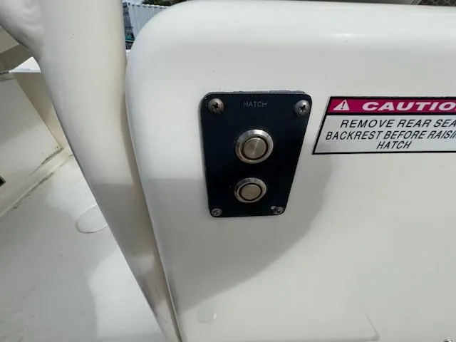 Slide: The Image of 2015 Cobia 296 Center Console hatch buttons with caution label. - 44