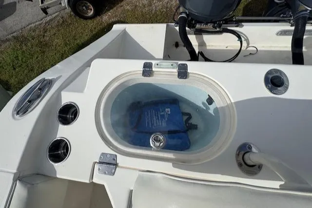 Slide: The Image of 2015 Cobia 296 Center Console livewell with clear lid and blue bag inside. - 46