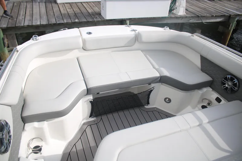 Slide: The Image of 2022 Sea Ray 250 SDX-OB boat interior with cushioned seating and modern design. - 10