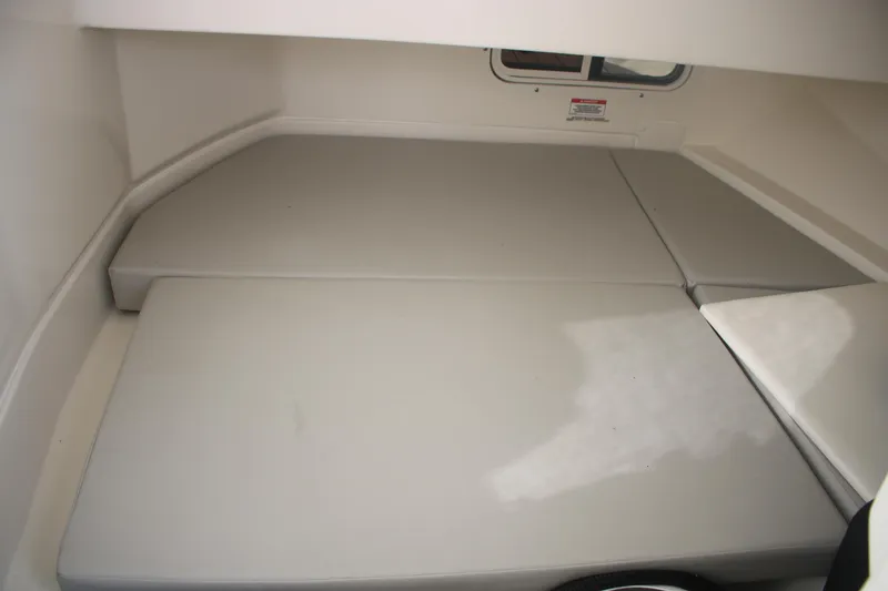 Slide: The Image of 2022 Sea Ray 250 SDX-OB cabin interior with cushioned seating area. - 12