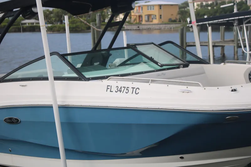 Slide: The Image of 2022 Sea Ray 250 SDX-OB boat docked by the water. - 3