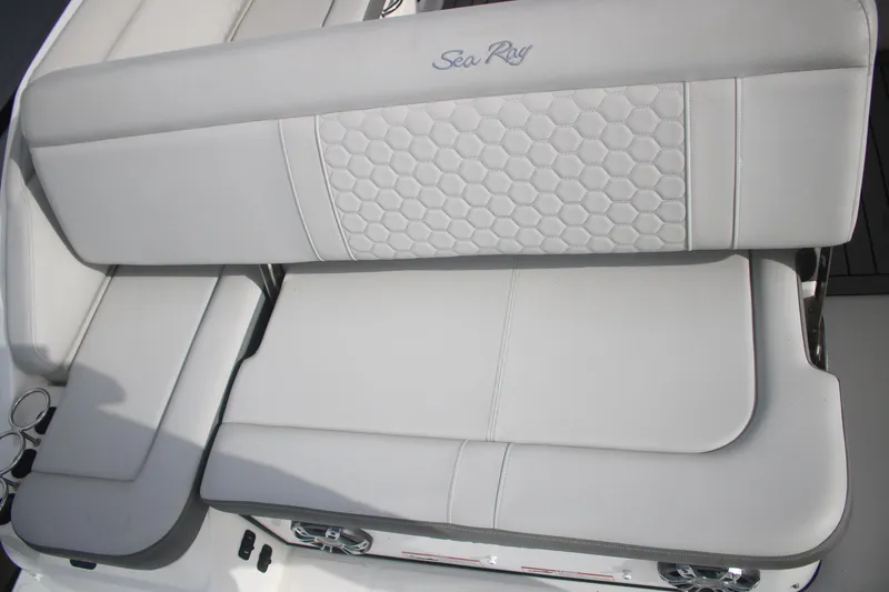 Slide: The Image of 2022 Sea Ray 250 SDX-OB boat seat with hexagonal pattern and logo. - 6