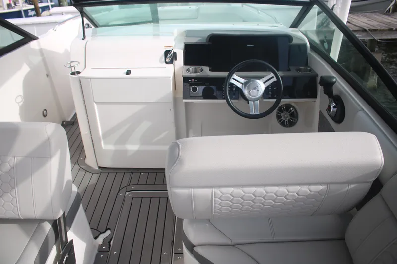 Slide: The Image of 2022 Sea Ray 250 SDX-OB boat interior with modern steering and seating. - 9