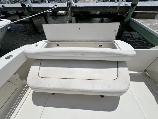Slide: The Image of 2003 Sea Ray 290 Amberjack boat seating area with storage, docked at marina. - 10