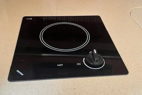 Slide: The Image of 2003 Sea Ray 290 Amberjack stovetop with single burner and control knob. - 14