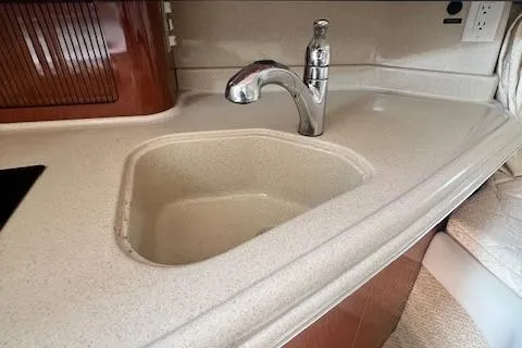 Slide: The Image of 2003 Sea Ray 290 Amberjack kitchen sink with modern faucet and countertop. - 18