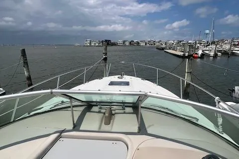 Slide: The Image of 2003 Sea Ray 290 Amberjack boat docked in a marina with cloudy skies. - 23